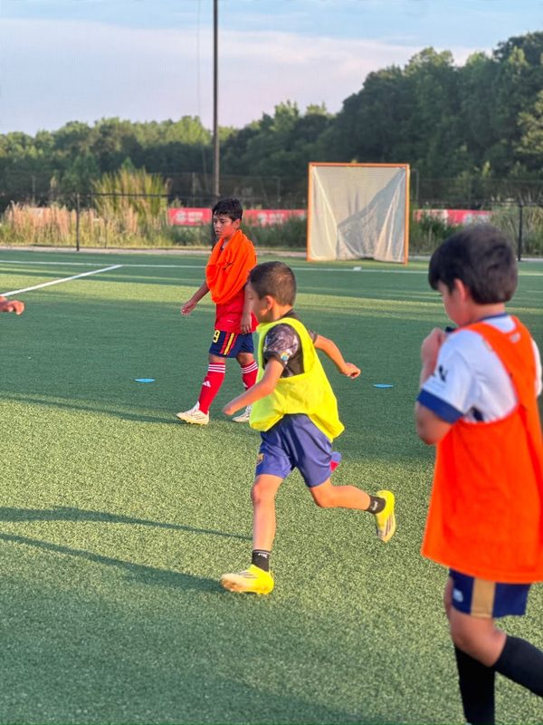 Youth players training on field in Charlotte
